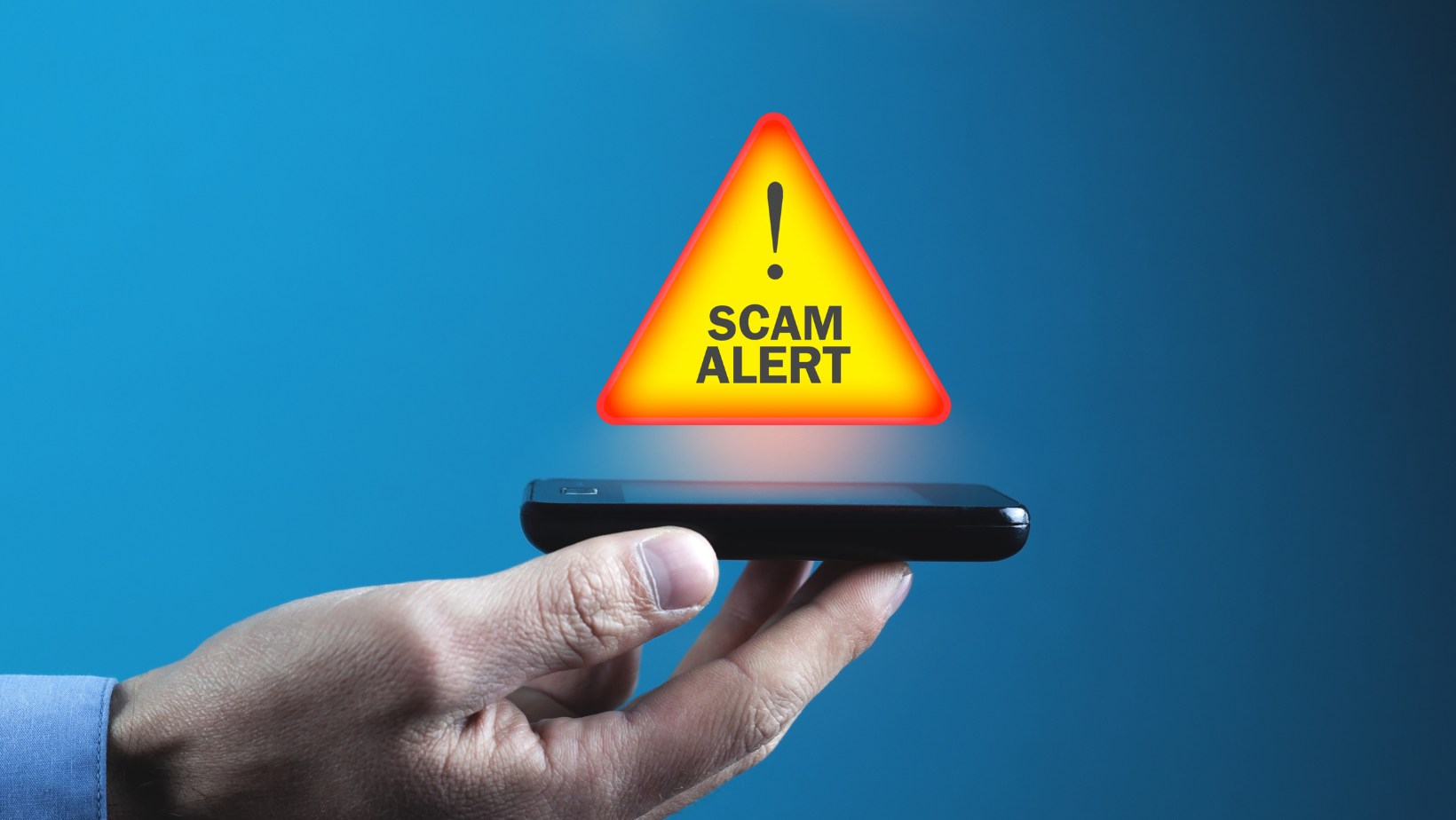A mobile phone showing a scam alert
